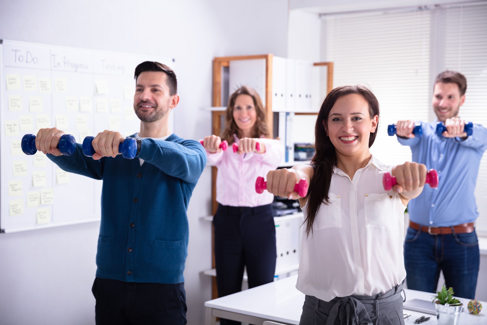 Businesspeople Exercising With Dumbbells