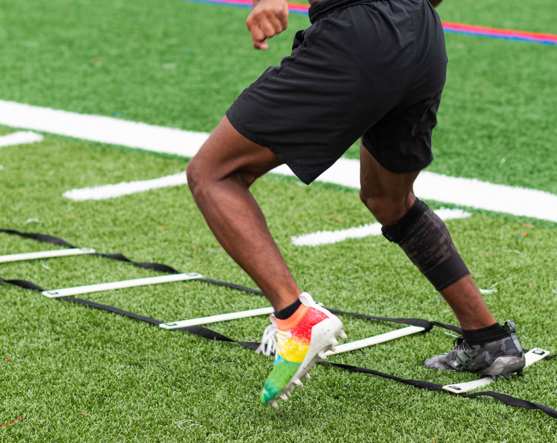 Athlete performing ladder drills on sports field